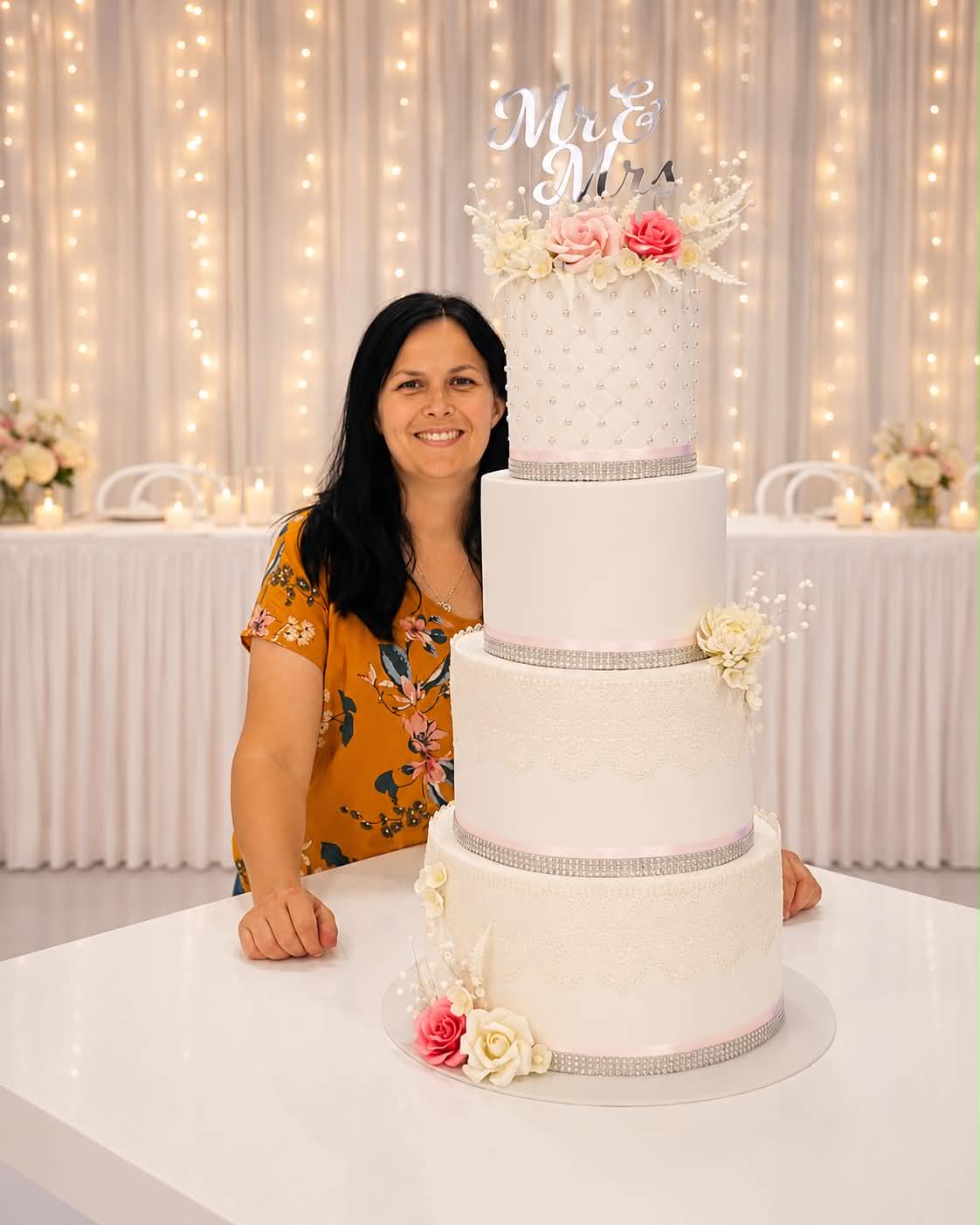 Single tier arch shaped white marble fondant wedding cake with a large pink protea, green pincushion proteas, eucalyptus and lavender floral arrangement on a silver cake stand